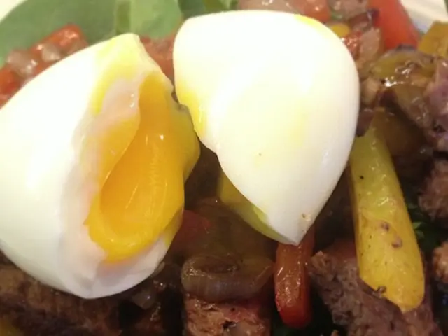 Here in this picture we can see a boiled egg and other meat item present in a bowl.