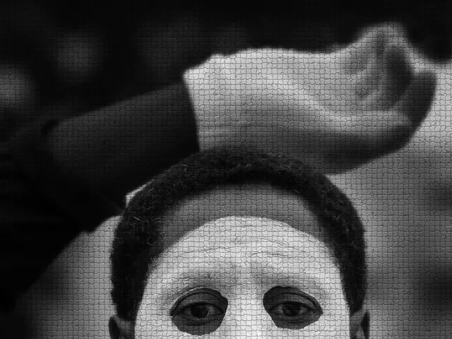 In the picture I can see a person who is wearing a face mask and hand gloves. This picture is black...