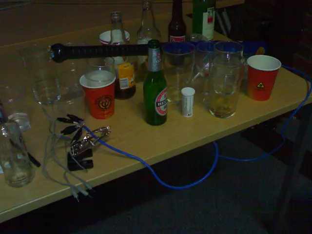 In this image there is table, on that table there are glasses, beer bottles and a baseball bat with...