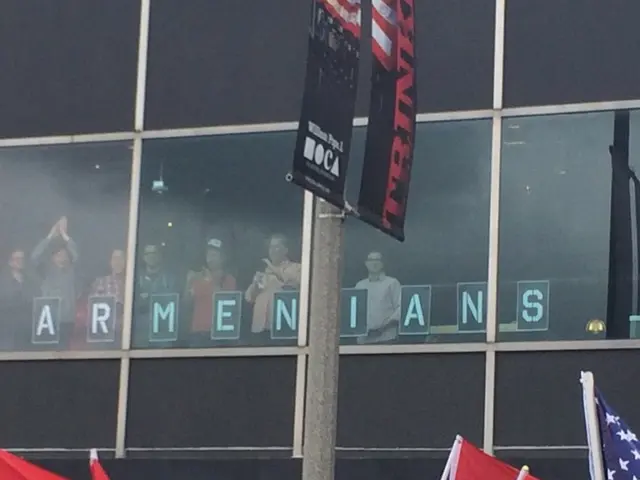 In this picture I can see few people standing near glass window and watching, down few people are...